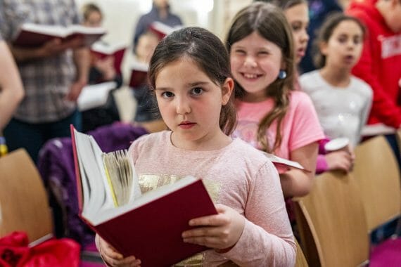 girls smiling while reading siddur